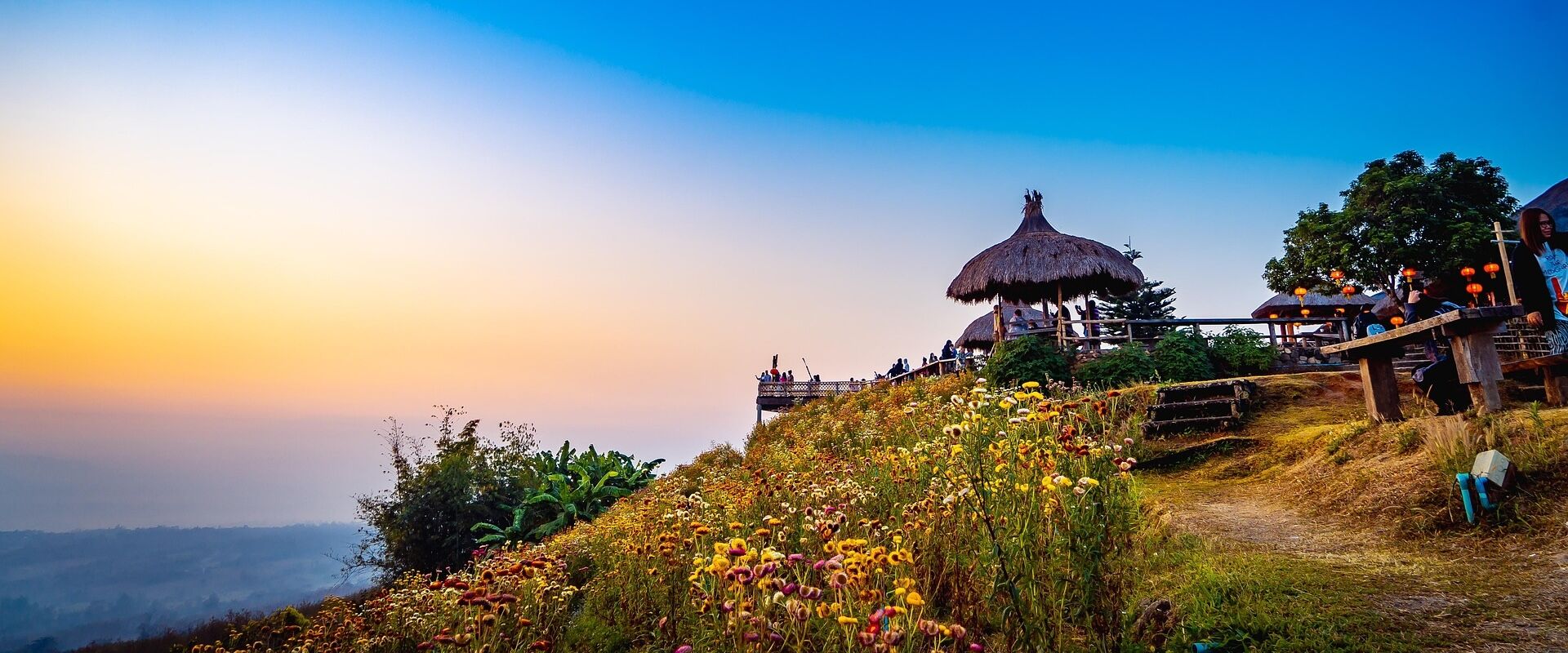 Mae Chaem’s serene countryside at sunset on a Mae Chaem Travel banner by Legend Travel Group.